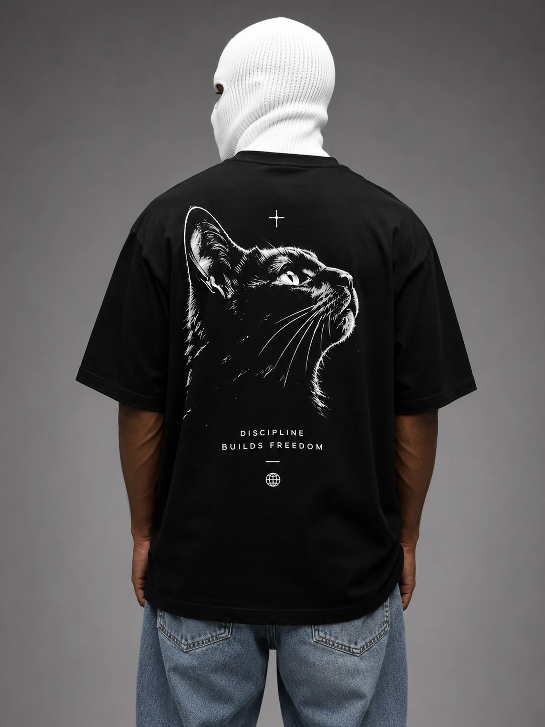 Discipline Builds Freedom black cat print on a black oversized tee