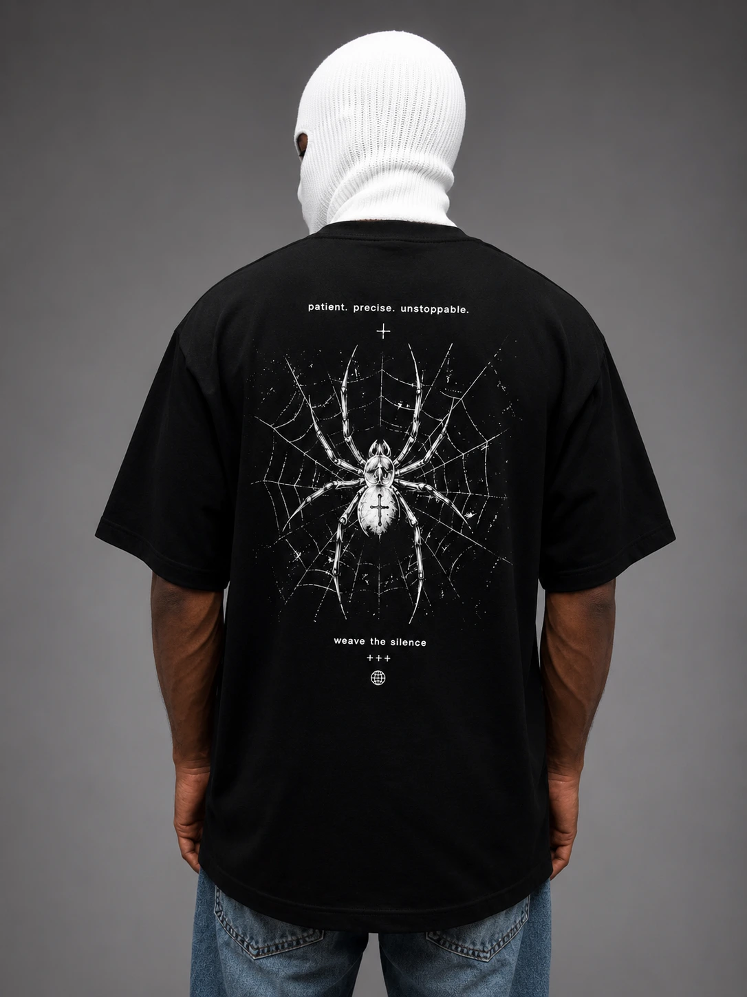 Weave the Silence web spider print on a black oversized tee